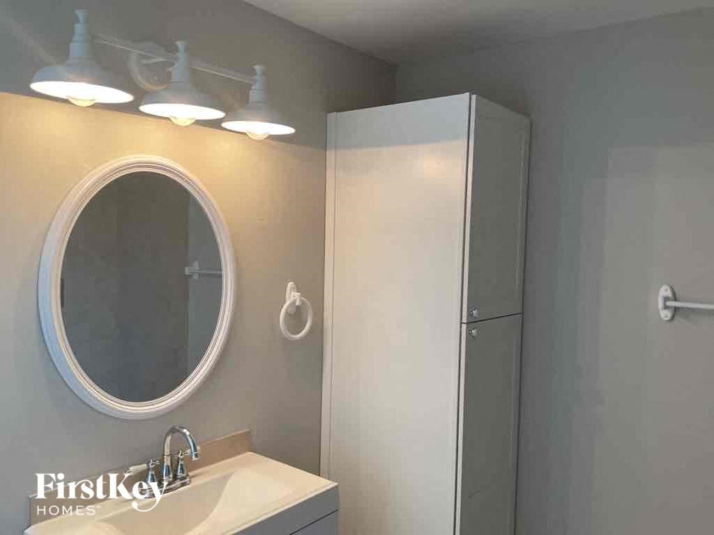 a bathroom with a mirror and a sink and a shower