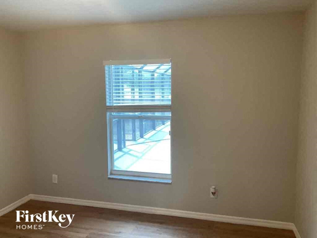 a living room with a window and a hard wood floor