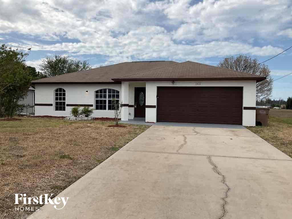 a white house with a driveway and a garage door