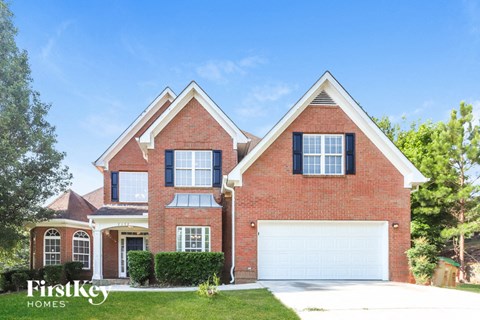 a red brick house with a white garage door