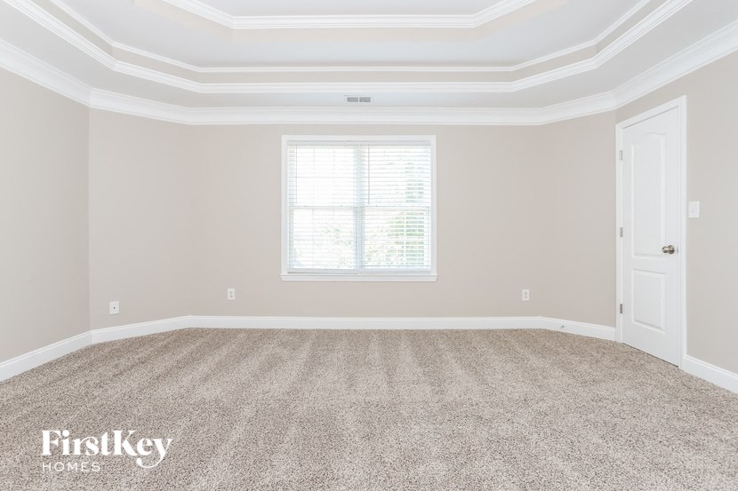 a empty room with carpet and a window