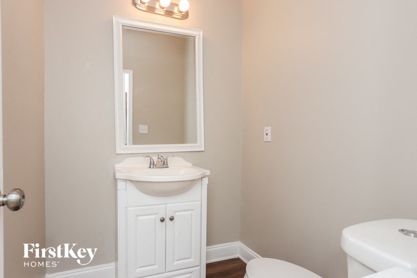 a bathroom with a sink and a mirror and a toilet