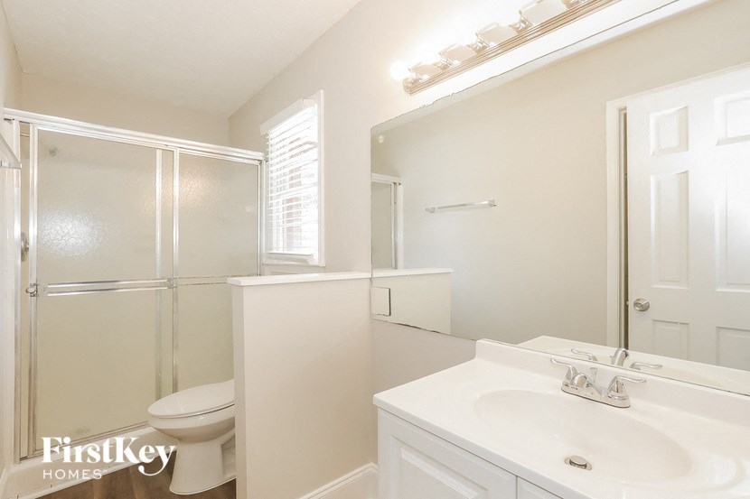 a bathroom with a sink toilet and a shower