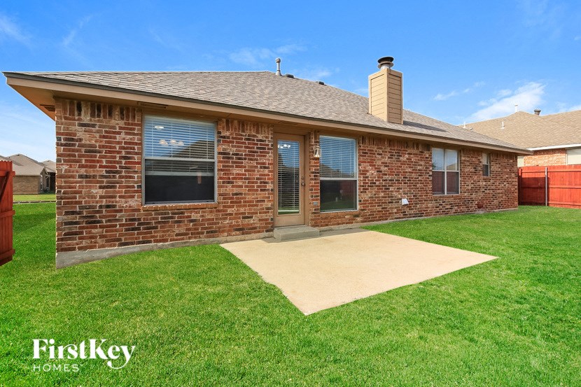 A brick house with a brown roof and a brown door.