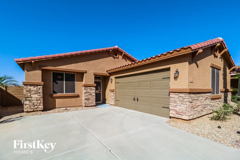 a brown house with a garage and a driveway