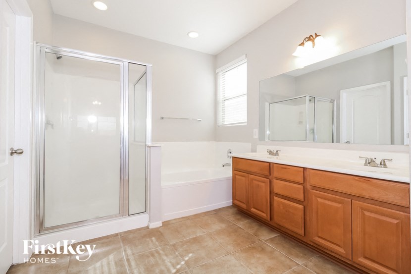a bathroom with a shower and a sink and a bath tub