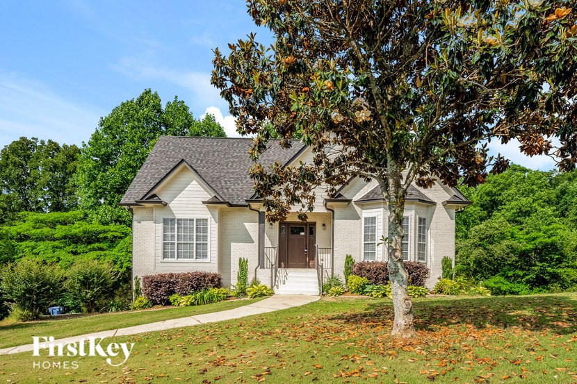 A house with a tree in front of it.