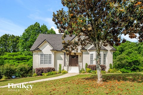 A house with a tree in front of it.