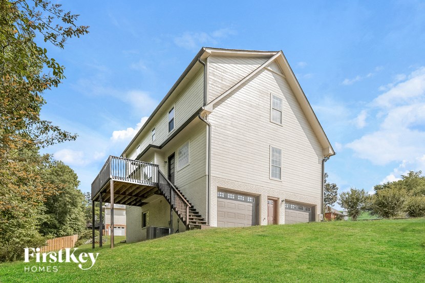 A two-story house with a balcony on the upper floor.