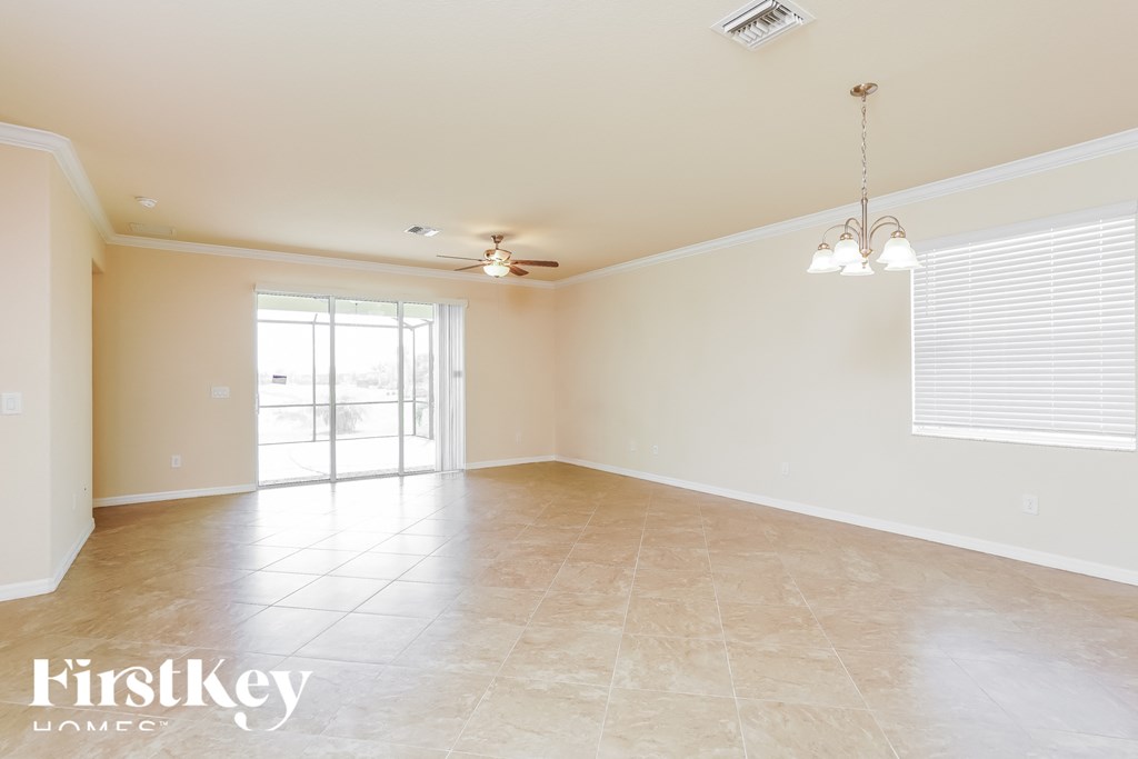 an empty living room with a sliding glass door to the patio
