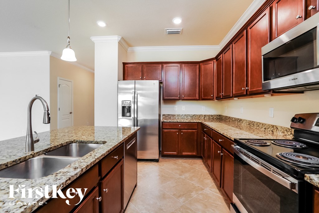 a kitchen with stainless steel appliances and granite counter tops