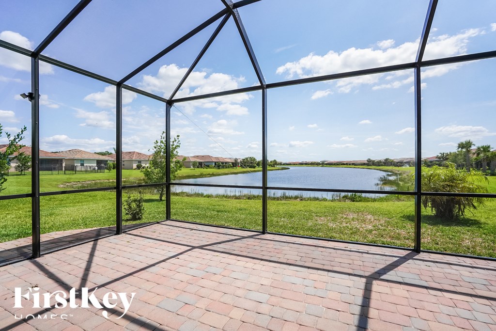 a view of the lake from inside a conservatory with glass doors