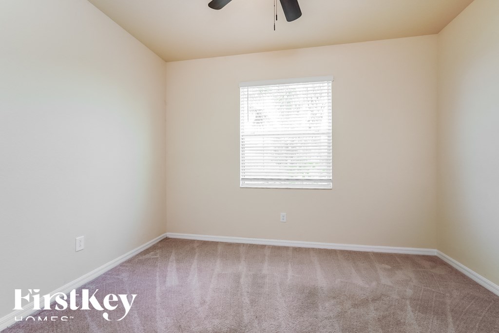 a room with a carpeted floor and a window