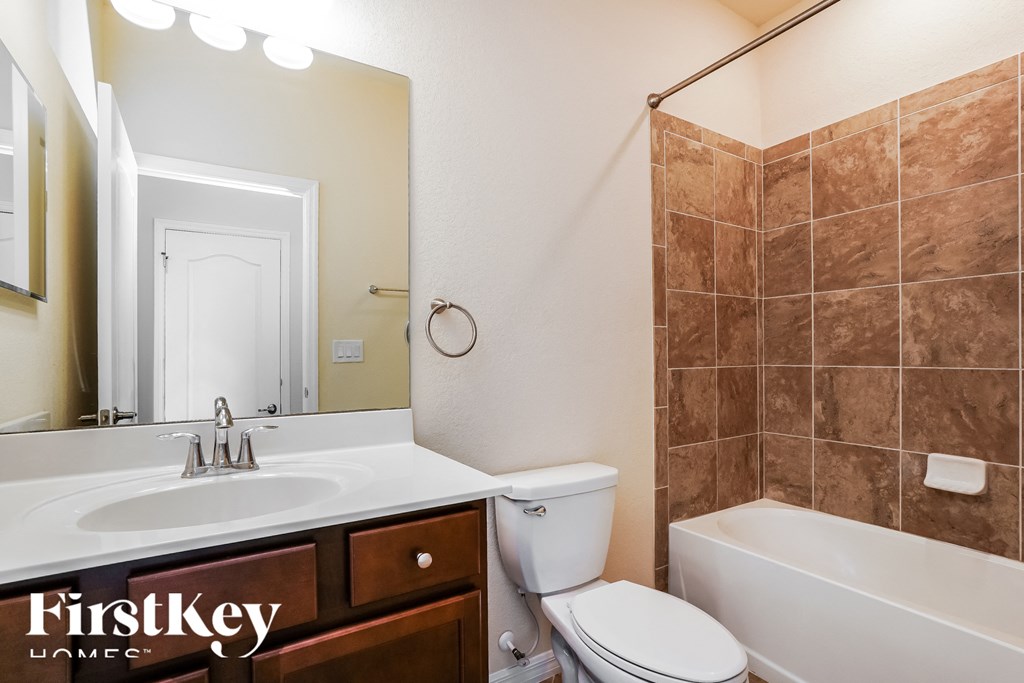 a bathroom with a sink toilet and a tub