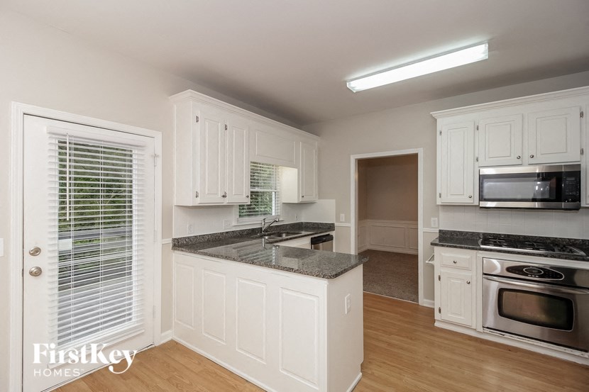 a kitchen with white cabinets and a counter top