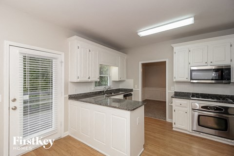 a kitchen with white cabinets and a counter top
