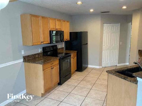a kitchen with black appliances and wooden cabinets