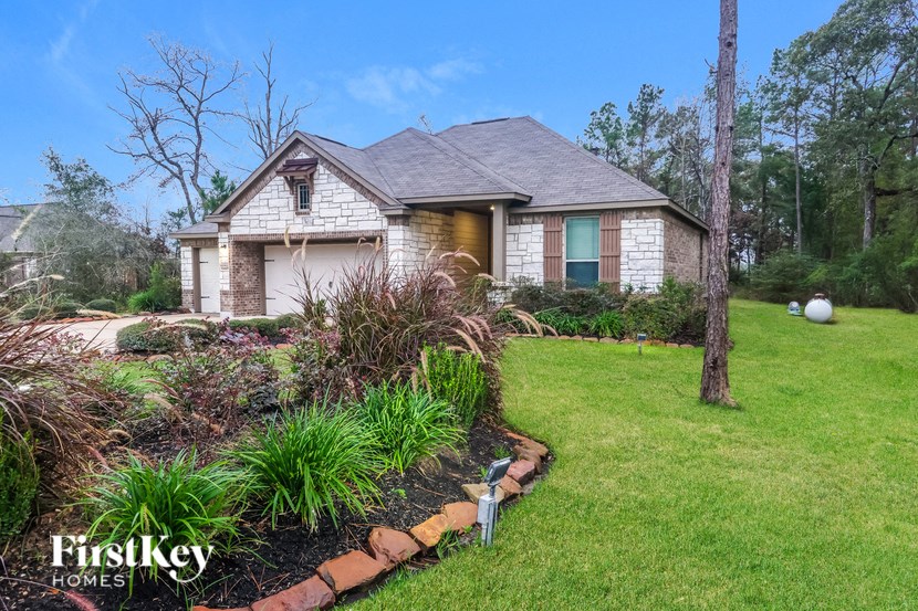 a small house with a lawn and a garden