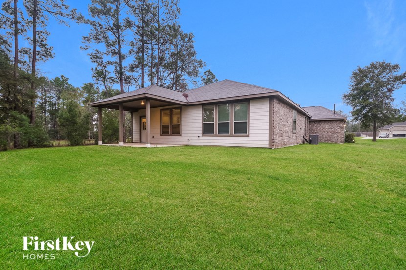 a small bungalow with a green lawn in front of it