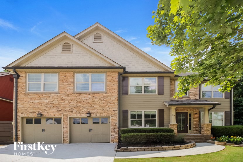 a large brick house with two garage doors