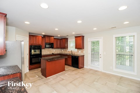 a kitchen with wooden cabinets and black appliances