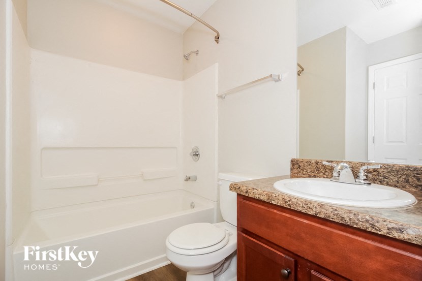 a bathroom with a sink toilet and a bath tub