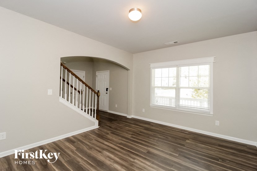 A room with wooden floors and a staircase.