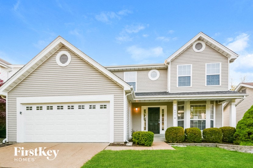 a white house with a white garage door