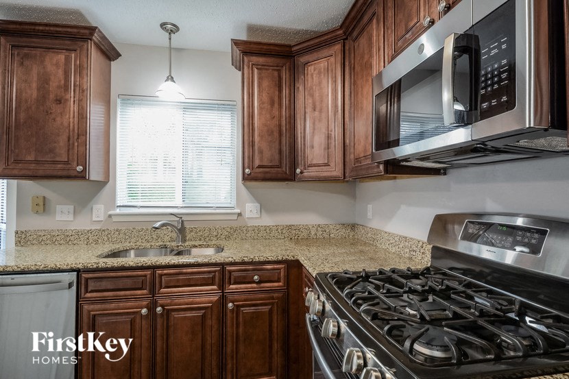 a kitchen with a stove and a microwave