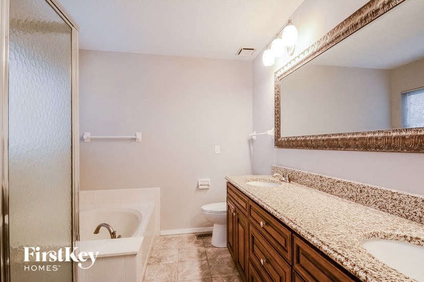 a bathroom with a sink and a toilet and a shower
