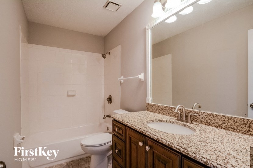 a bathroom with a sink and a toilet and a shower
