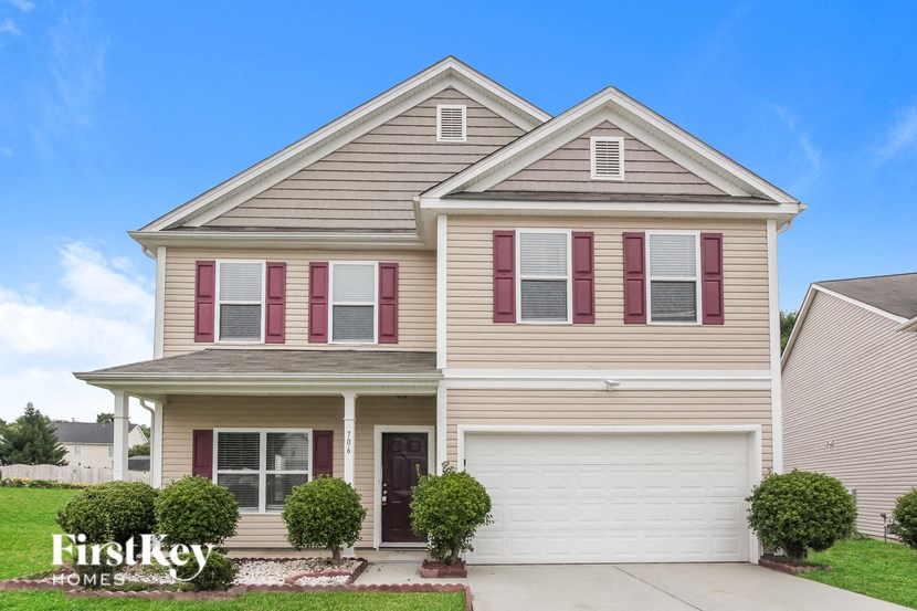 a house with red shutters and white siding