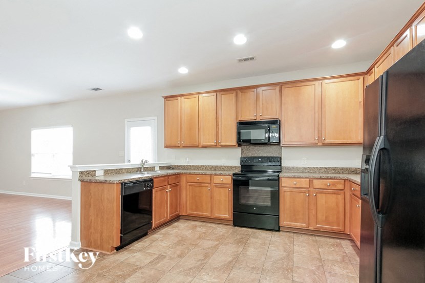 a kitchen with black appliances and wooden cabinets
