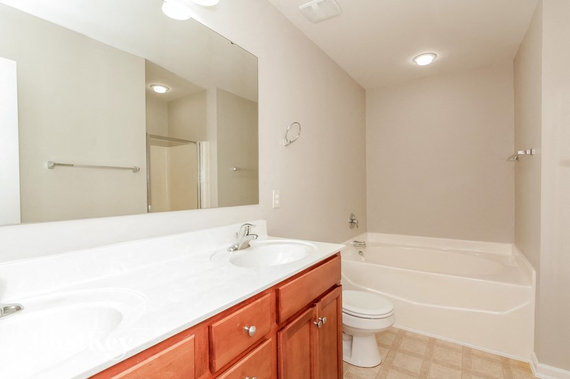 a bathroom with a sink toilet and a mirror