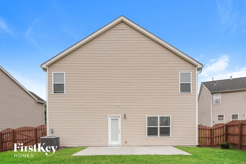 the outside of a house with a yard and a sidewalk