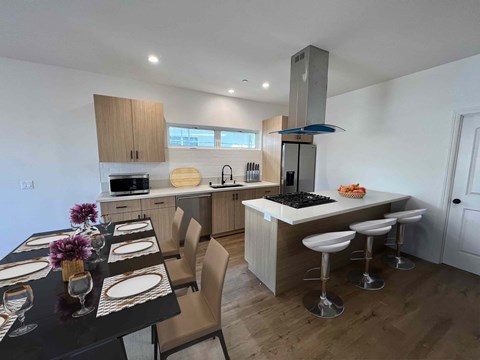 a kitchen and dining area with a table and chairs