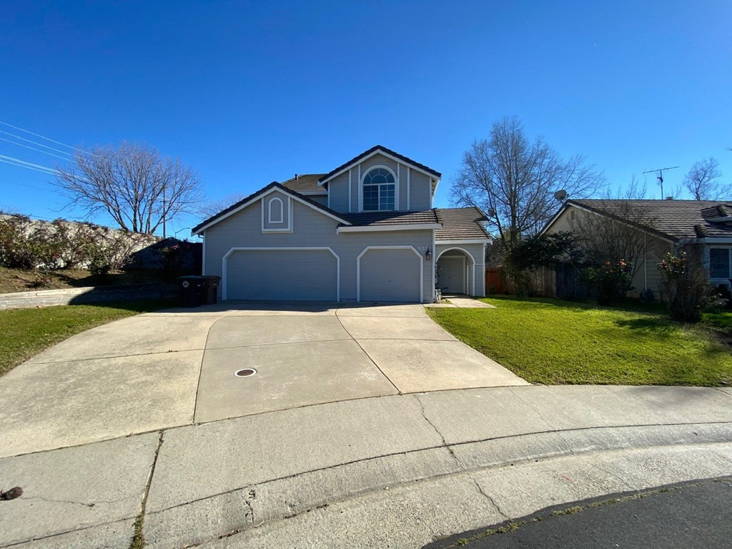 a house with a driveway and a blue garage door