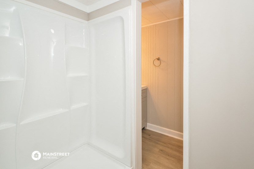 a small bathroom with a shower and a closet