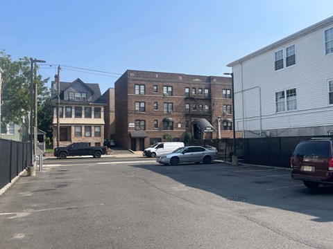 A parking lot with cars and buildings in the background.