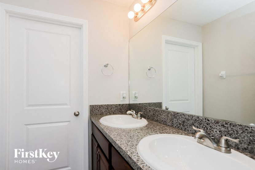a bathroom with two sinks and a mirror
