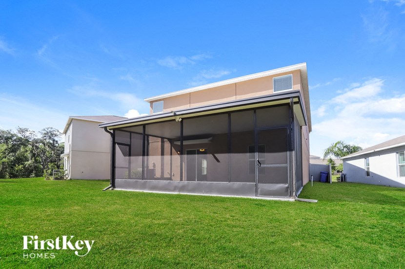 a glass enclosure with a lawn in front of a house