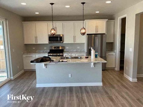 a kitchen with white cabinets and a counter top