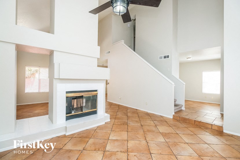 a living room with a fireplace and a staircase