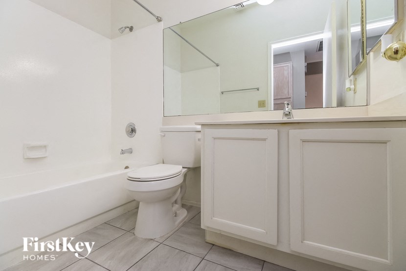 a bathroom with a toilet and a sink and a mirror