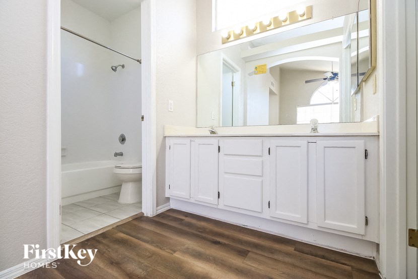 a bathroom with a toilet and a sink and a mirror