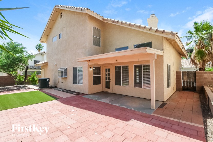a home with a patio and a driveway in front of it