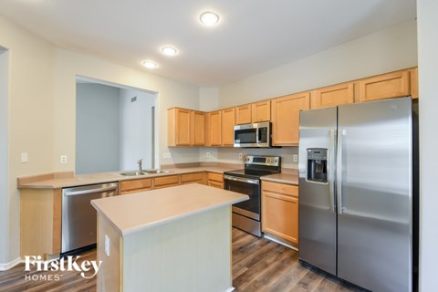 A kitchen with wooden cabinets and stainless steel appliances.