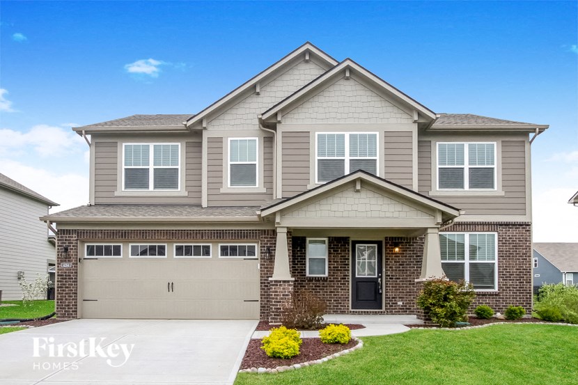 A house with a garage and a front yard.