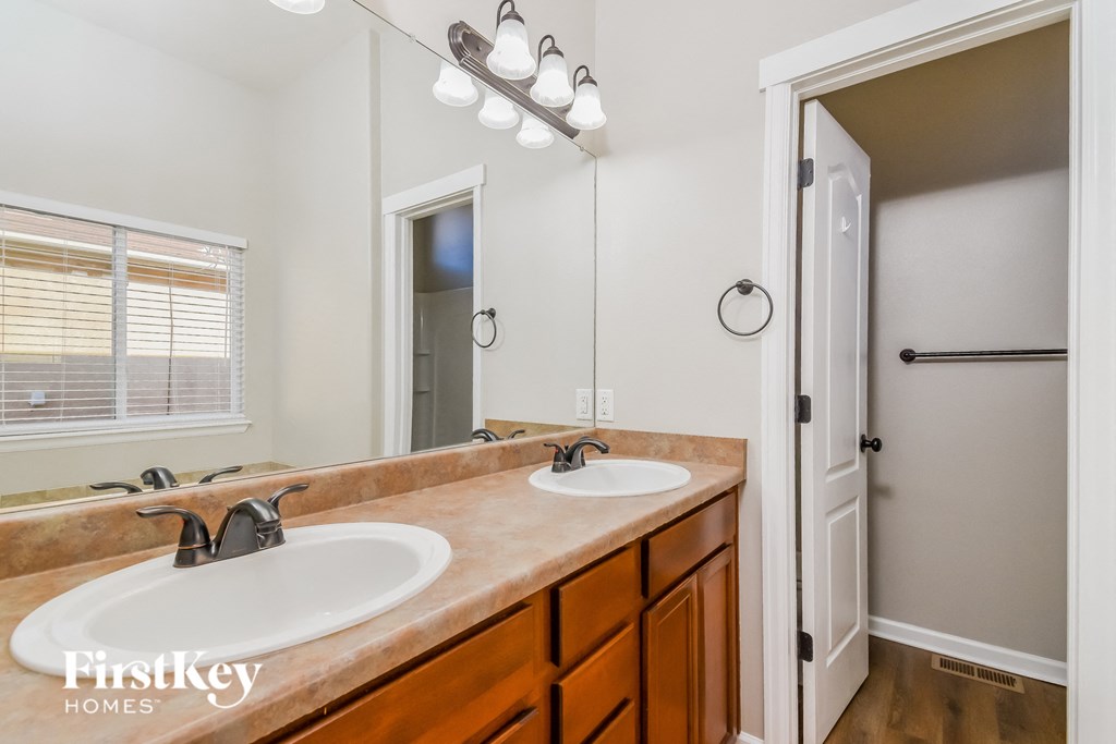 a bathroom with two sinks and a large mirror