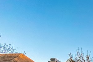 A house with a teal colored garage door is for sale by FirstKey Homes.